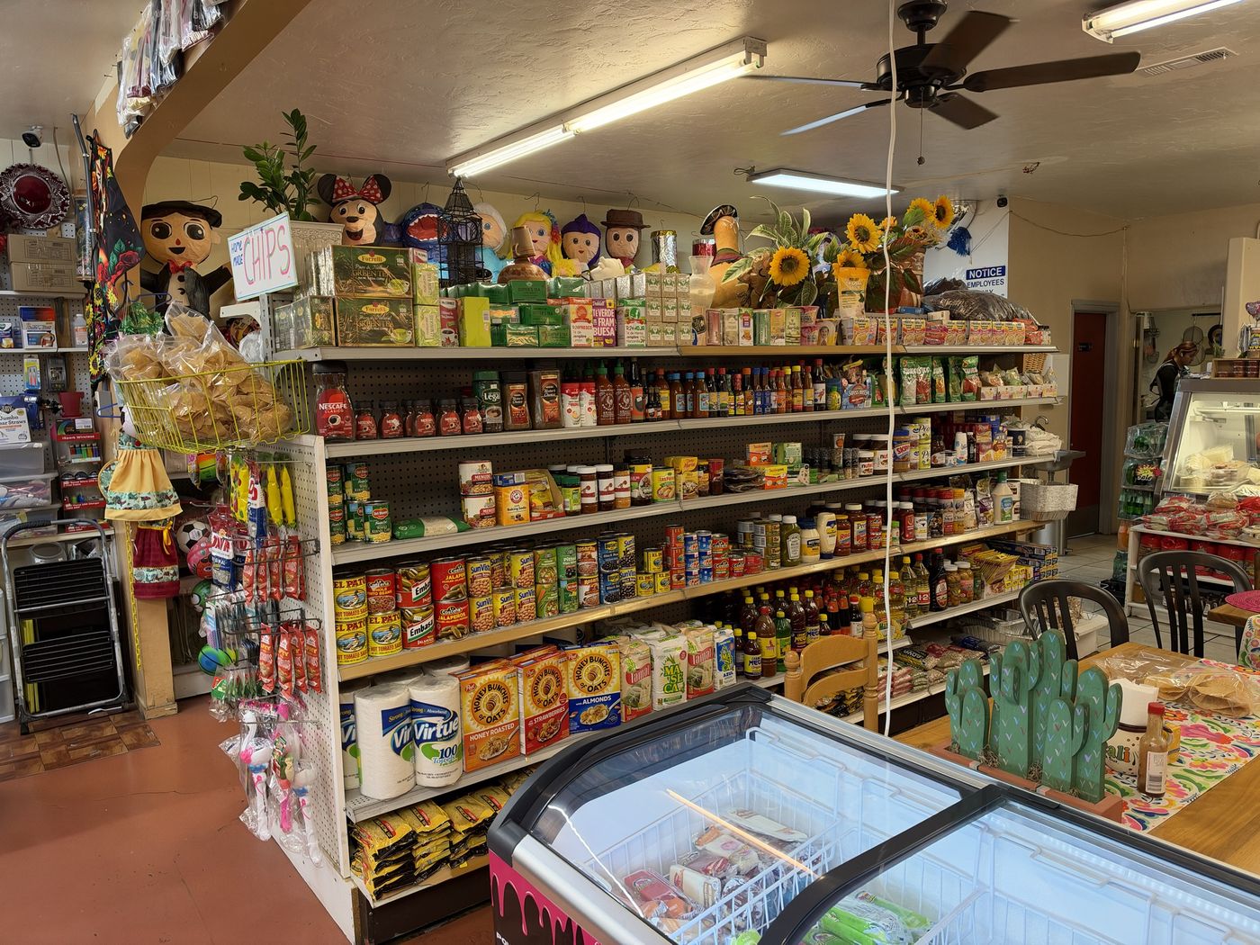 Grocery aisle with Mexican canned goods, salsas, coffee and spices