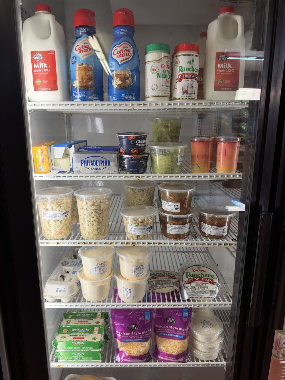 Dairy fridge with crema, queso fresco, ceviche and ensalada de coditos